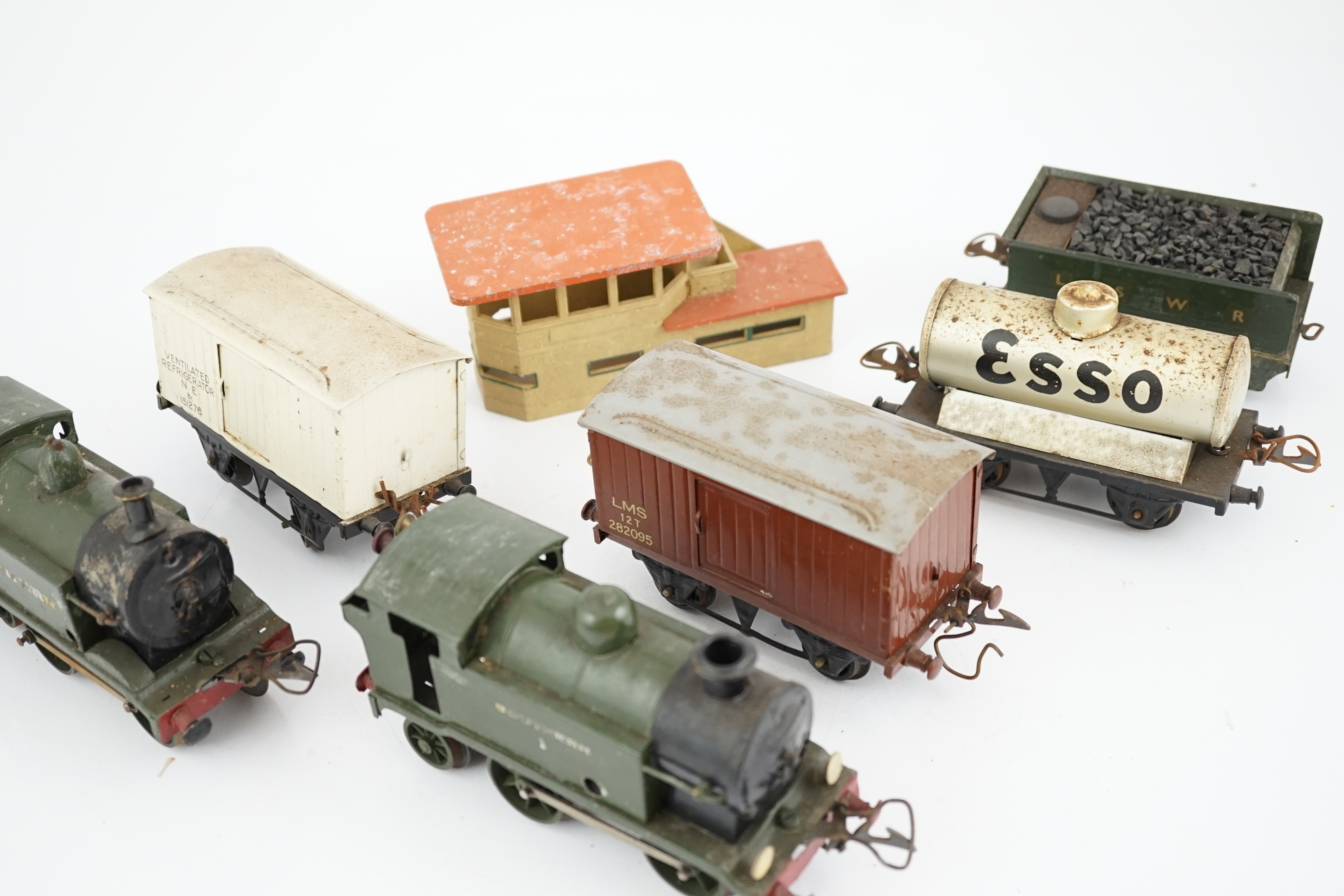Fourteen 0 gauge tinplate etc. railway items, including three clockwork locomotives; an LSWR 4-4-0 tender loco, an SR 0-4-4T loco and an SR 0-4-2T loco, together with nine Hornby freight wagons, a Bing milk traffic van a